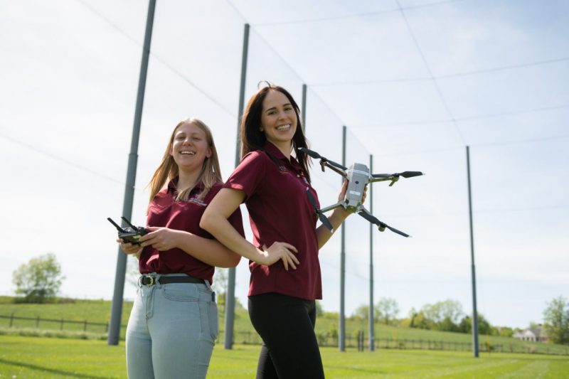 Virginia Tech Drone Park interns standing with a drone 